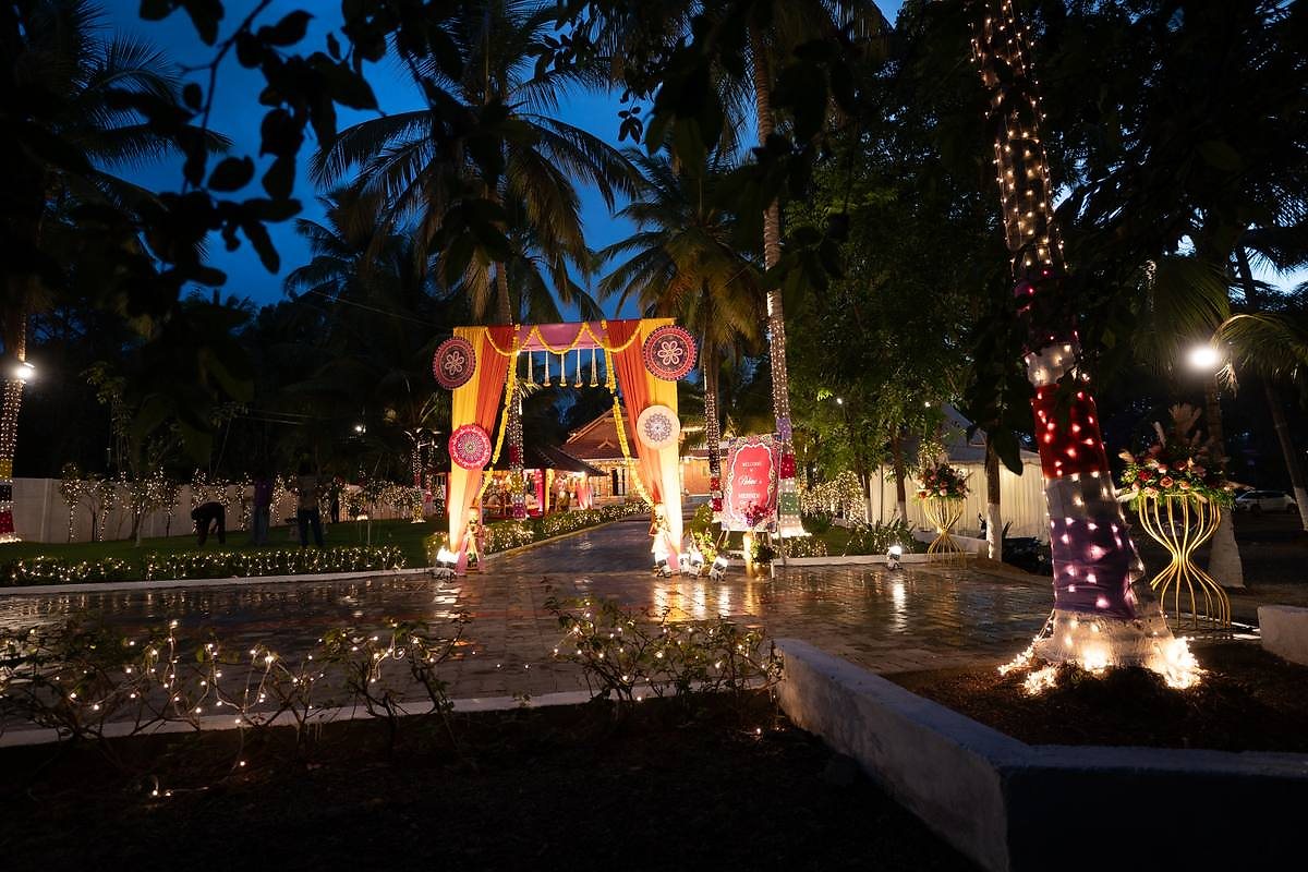 Lit floral archway on the evening pathway welcoming guests