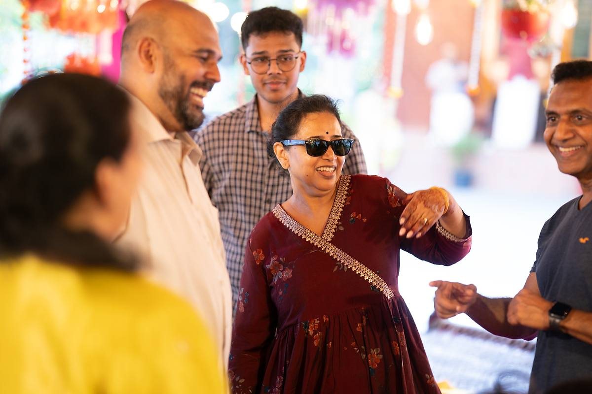 Guests laughing together during a celebration at Kalapura