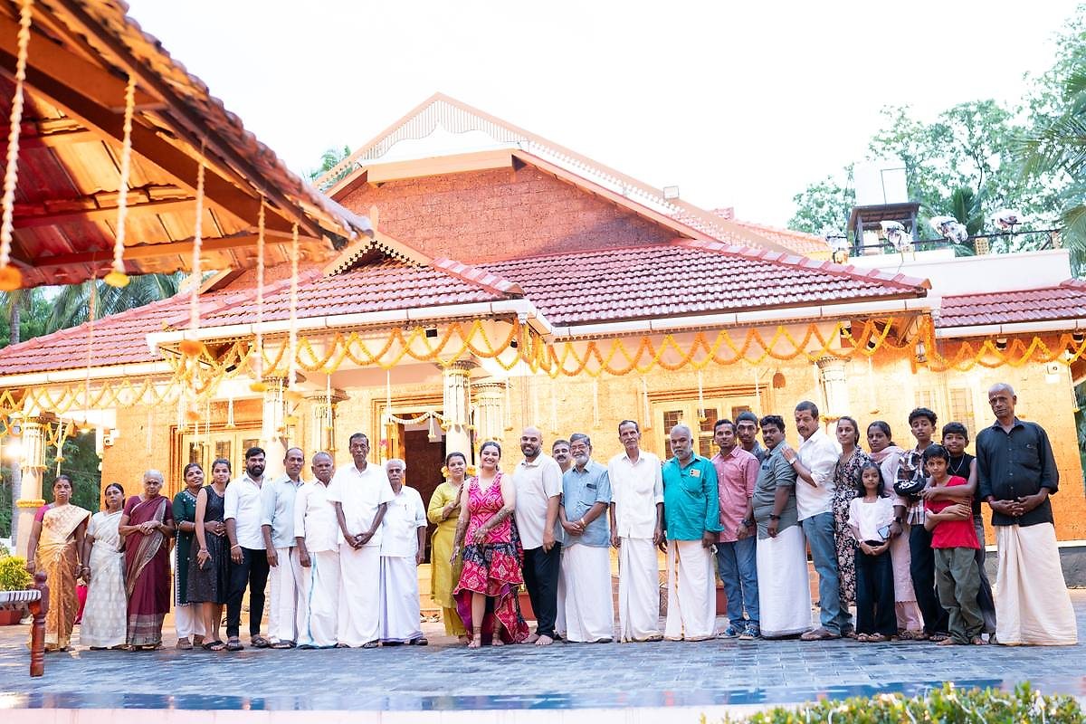 Extended family portrait outside the decorated Kalapura house