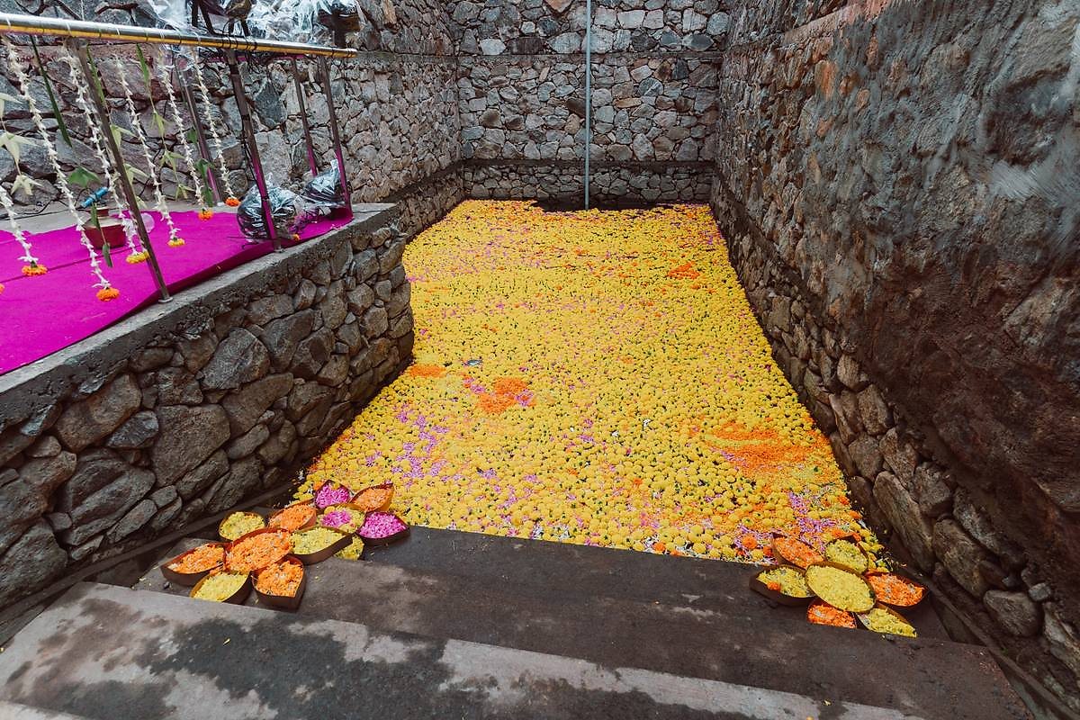 Stone pool filled with marigold and rose petals