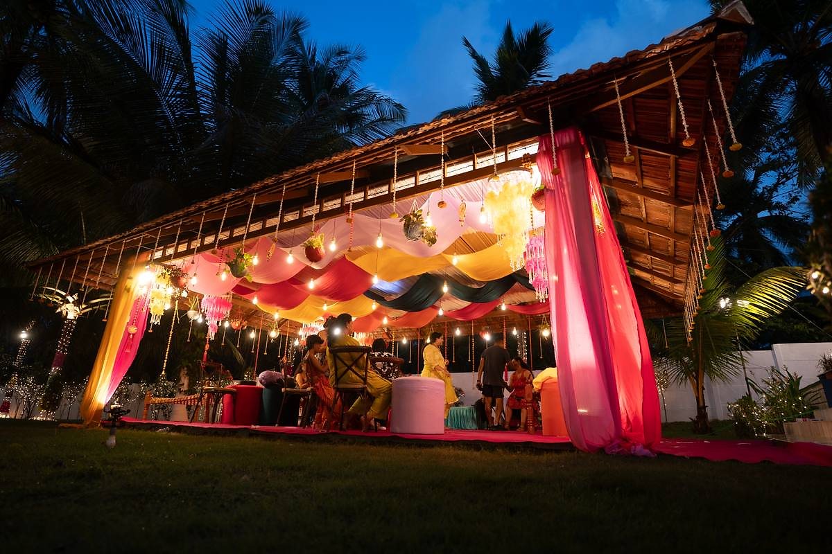 Colourful mandap ceiling decor with hanging lights and marigolds
