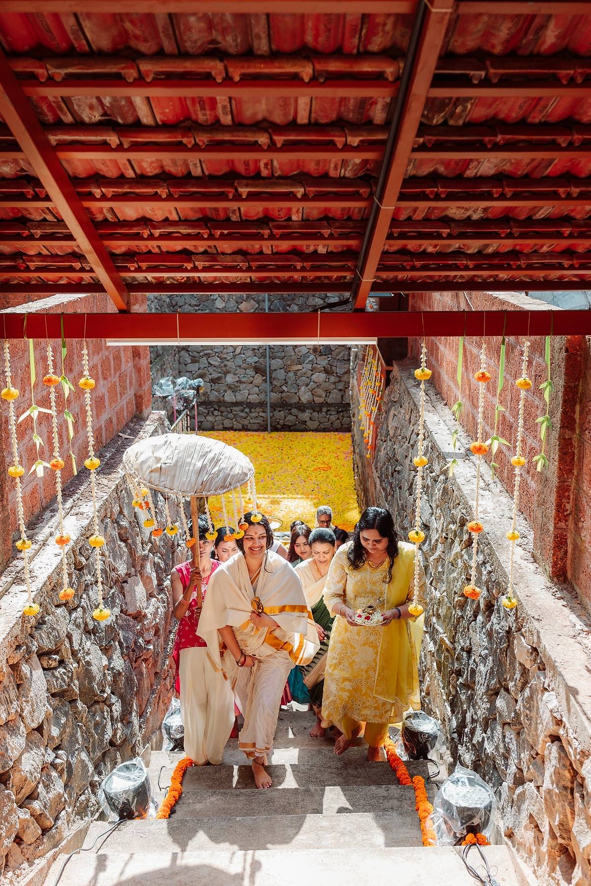 Ceremonial procession down the flower-decorated stone steps to the pond